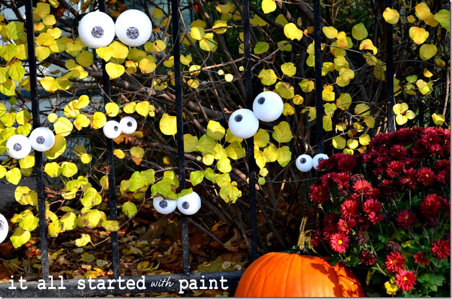 eyes-on-fence-for-halloween-with-pumpkin
