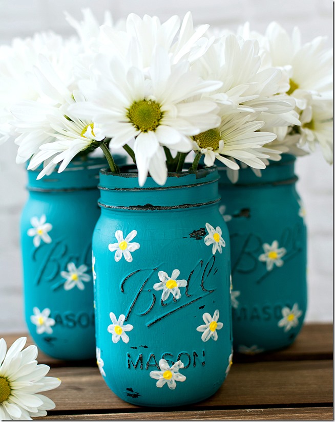 painted and distressed mason jars in teal with hand painted daisies