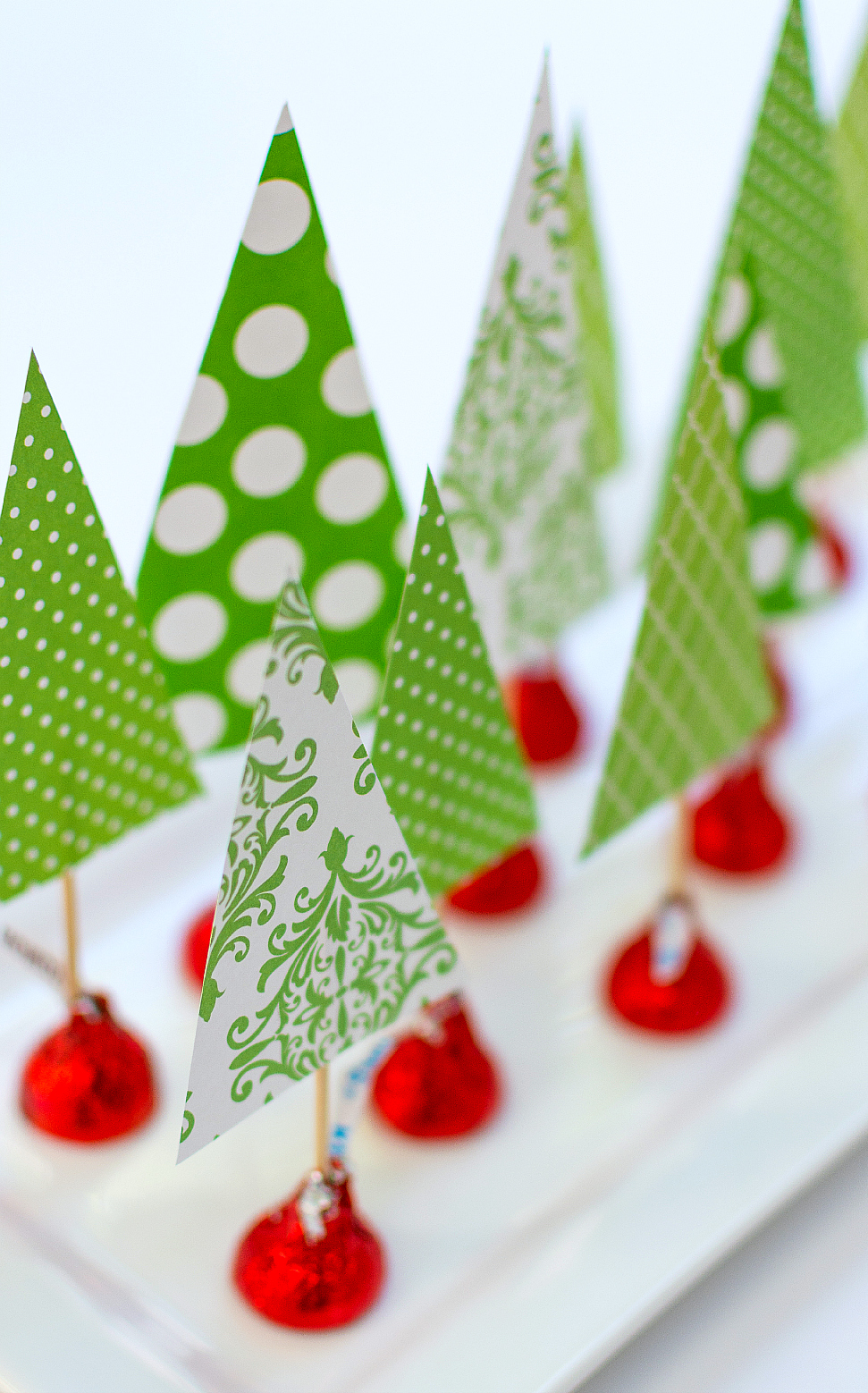 Christmas Crafts with Kids and Kisses. Easy kids crafts for Christmas. Easy paper tree centerpiece. Tutorial on how to make a Christmas tree centerpiece with Scrapbook Paper and Hershey Kisses.