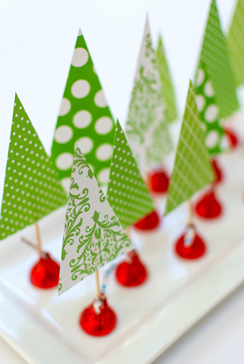 Christmas Crafts with Kids and Kisses. Easy kids crafts for Christmas. Easy paper tree centerpiece. Tutorial on how to make a Christmas tree centerpiece with Scrapbook Paper and Hershey Kisses. Christmas Craft for Kids Using Hershey Kisses