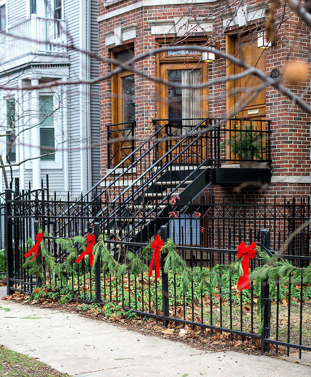 Iron Fence Decorated with Garland and Red Bows