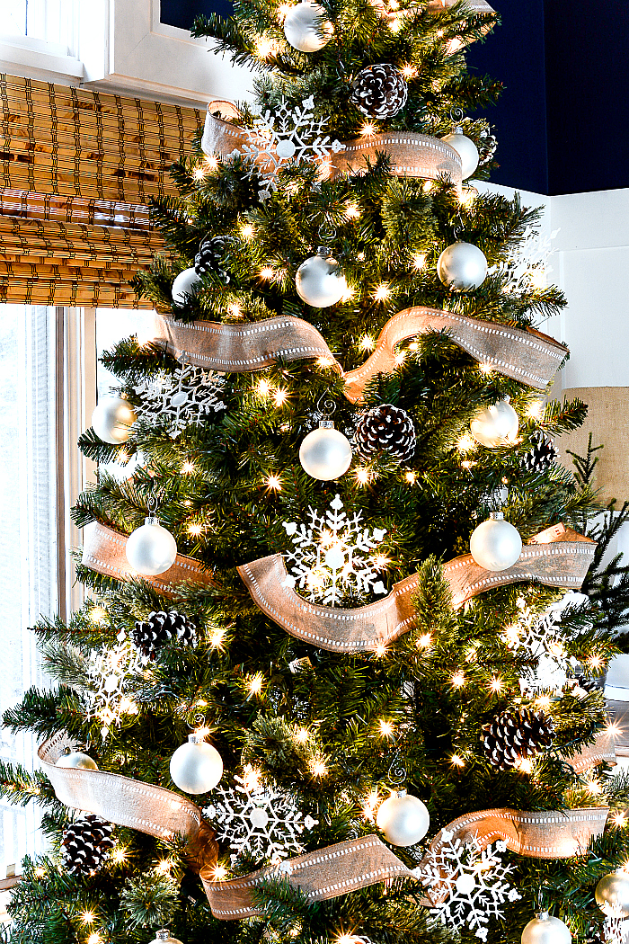 Christmas Tree with Burlap Ribbon and Pine Cones. Natural, Rustic Christmas Tree Idea. White oranments, painted snowy pine cones, snowflakes and burlap ribbon Christmas tree.