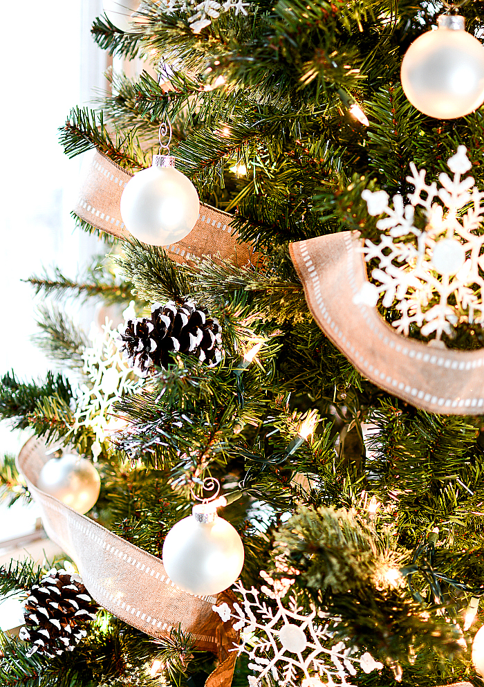 Christmas Tree with Burlap Ribbon and Pine Cones. Natural, Rustic Christmas Tree Idea. White oranments, painted snowy pine cones, snowflakes and burlap ribbon Christmas tree.