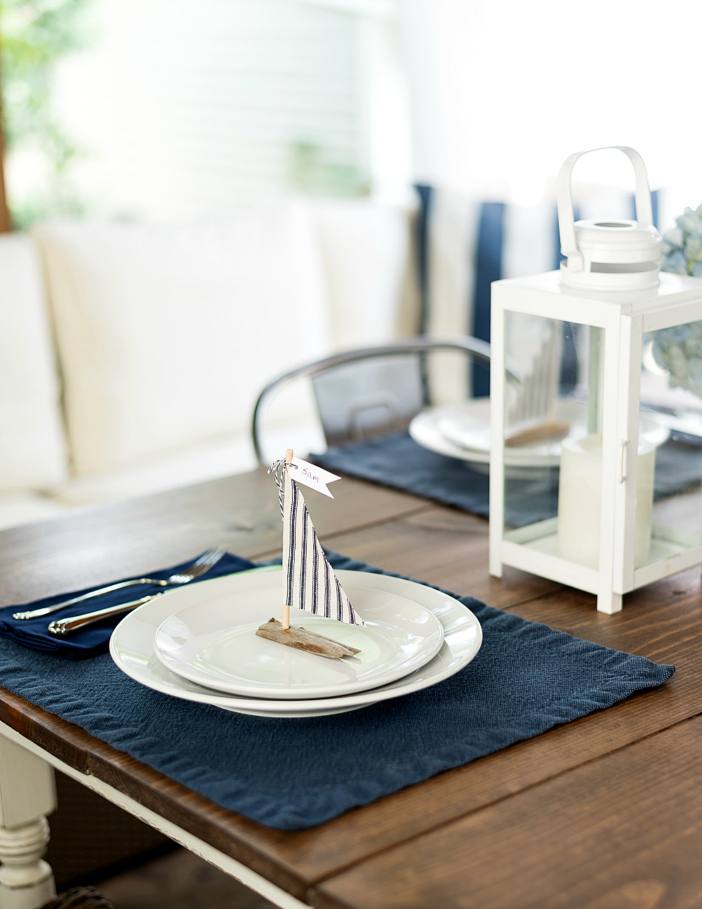 Wedding table setting ideas in navy white sailboats from driftwood