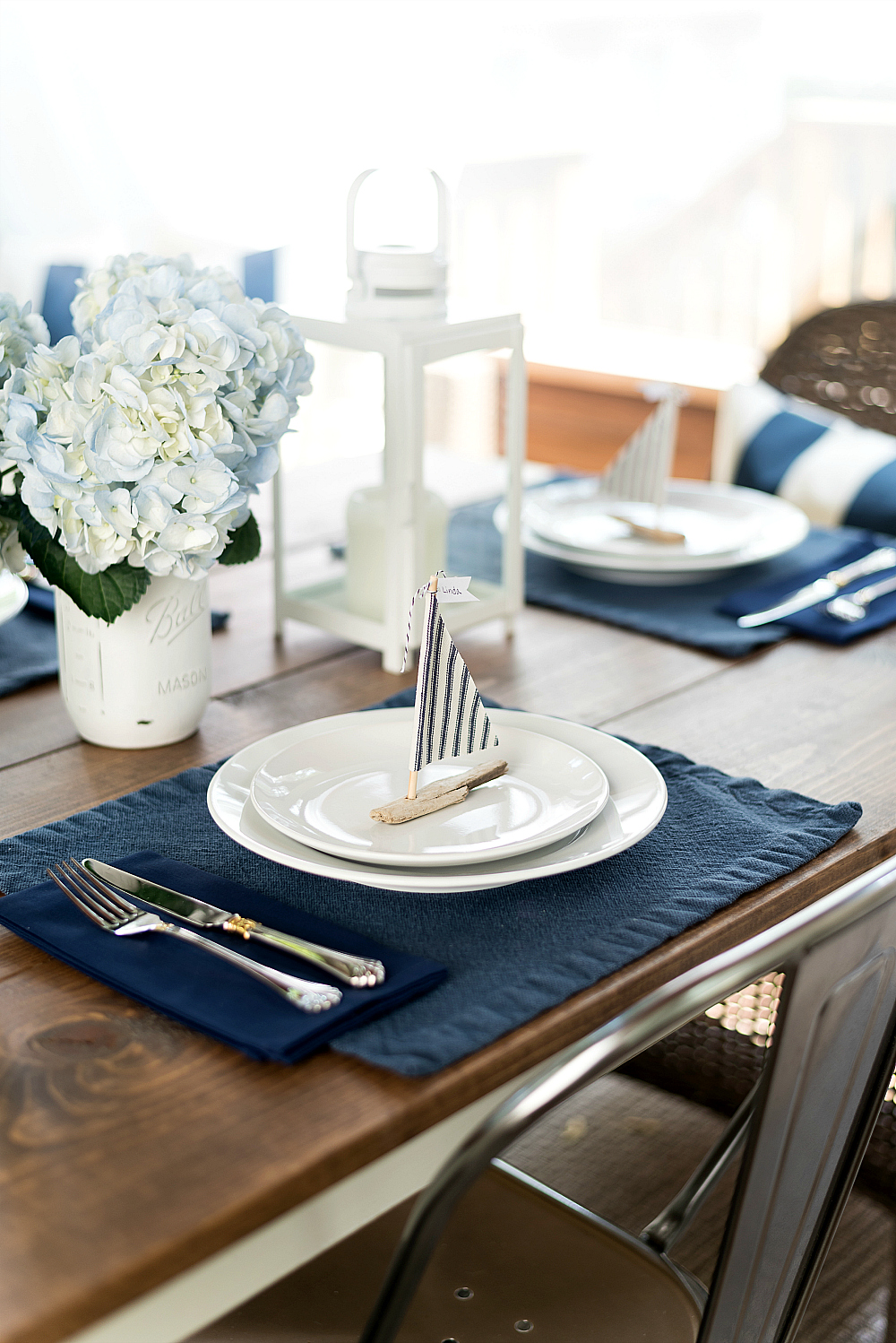 nautical table setting with driftwood sailboats