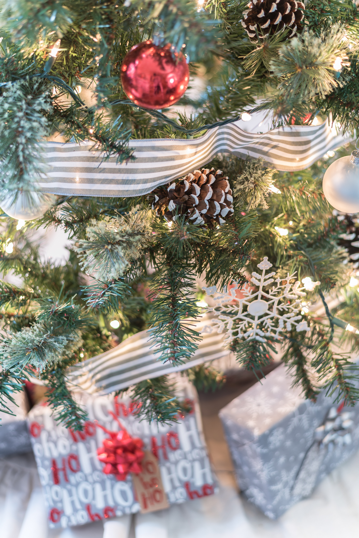 Christmas Tree in Gray, White and Red - Christmas Tree with Painted Pine Cones - Christmas Tree with Dollar Store Snowflakes - Decorating Christmas Tree with Ribbon in Gray and White Stripe.