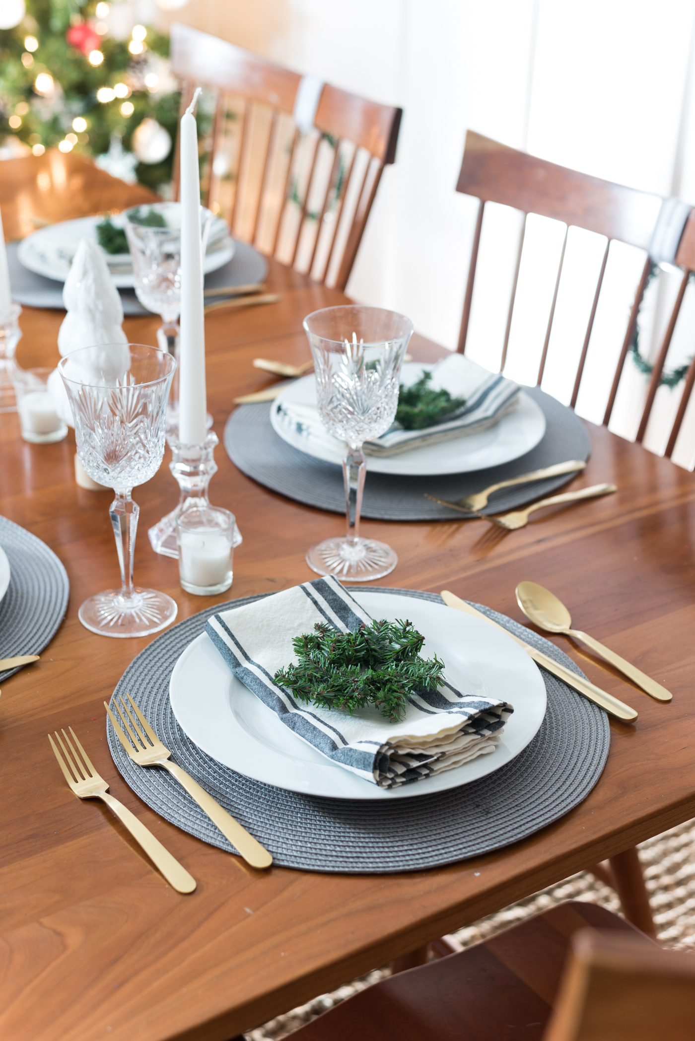 gold flatware from target. Christmas Table Setting in Gray, White, Gold. Gray and White Holiday Table Setting Idea. Mini Wreath Holiday Place Setting Idea. White mini Christmas Trees and Tapered Candles Holiday Table Centerpiece.