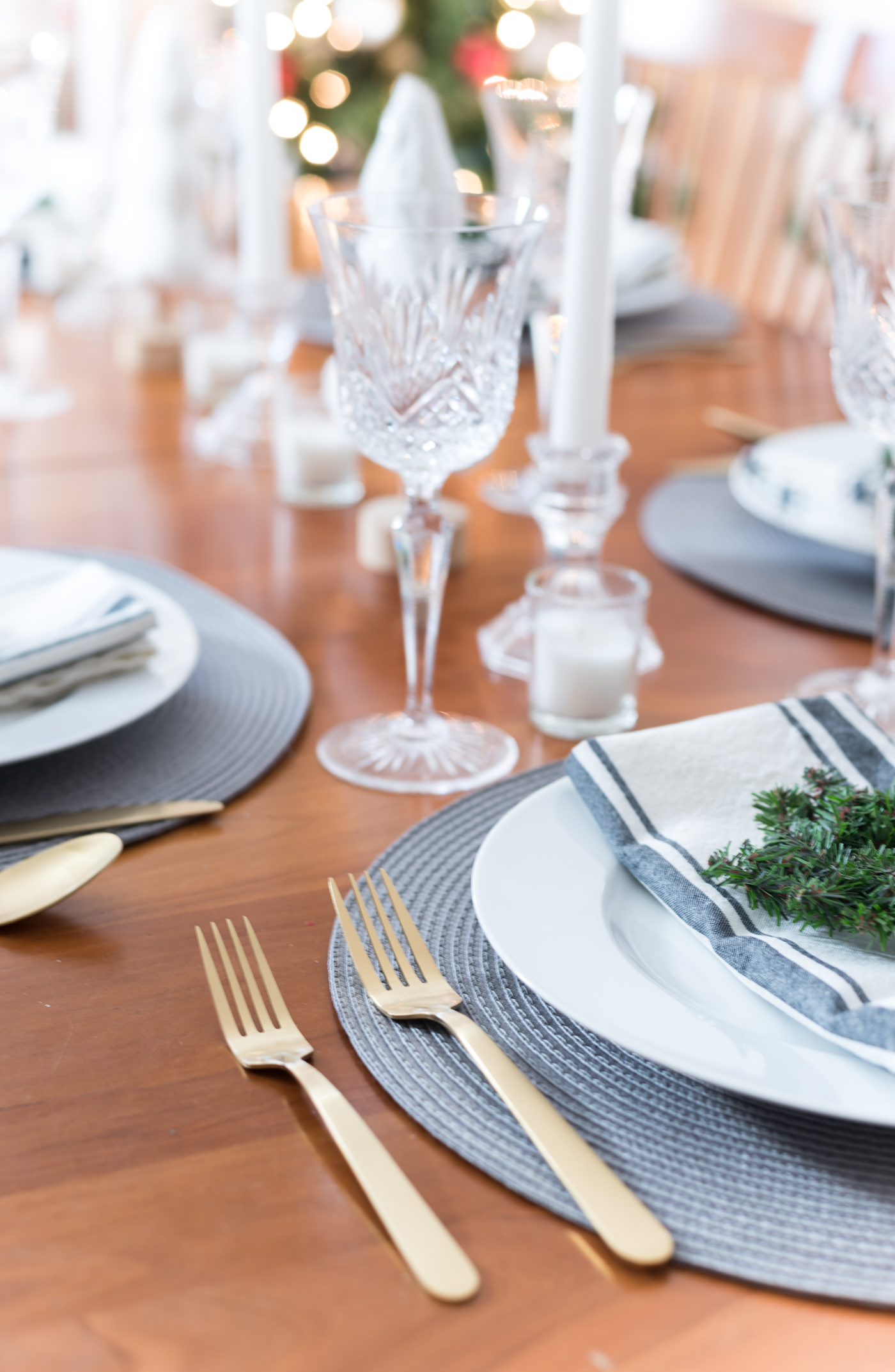 gold forks from target, gold flatware, holiday table with gold utensils. Christmas Table Setting in Gray, White, Gold. Gray and White Holiday Table Setting Idea. Mini Wreath Holiday Place Setting Idea. White mini Christmas Trees and Tapered Candles Holiday Table Centerpiece.