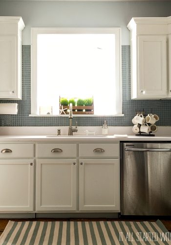 White Kitchen with Painted Builder Grade Cabinets, Blue Gray Tile Back Splash, White Counter Top