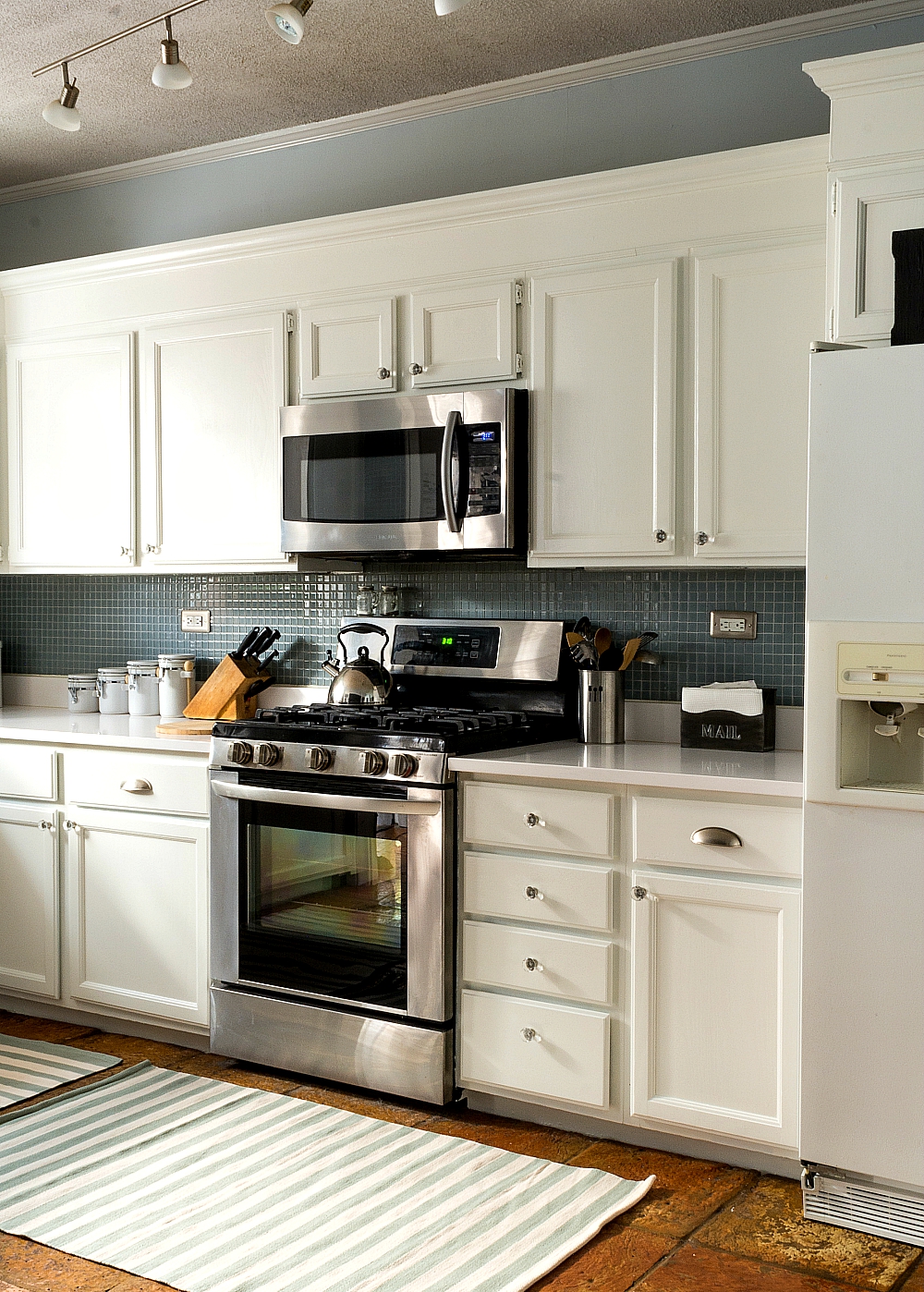 white-kitchen-cabinets-white-counter-tops-blue-gray-backsplash (20 of