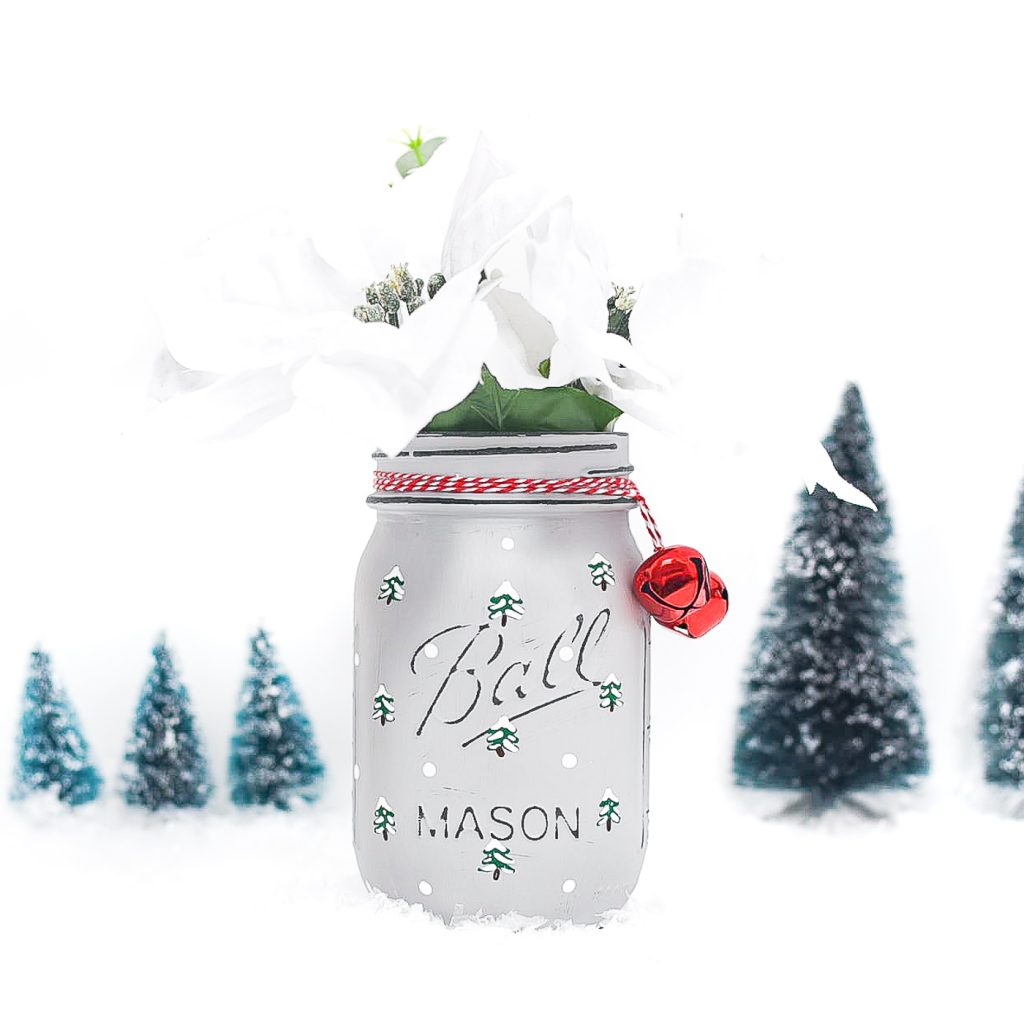 Painted snowy tree mason jar. Christmas tree mason jar craft. How to paint evergreen trees on mason jars. How to paint snowy Christmas trees. Winter craft mason jar.