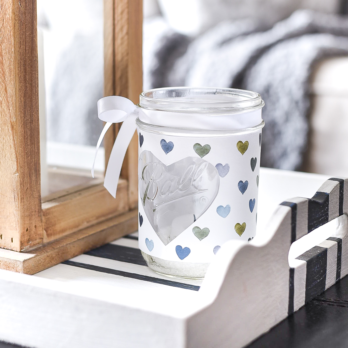 Heart Cut Out Mason Jar Votive - Easy Valentine Craft with Mason Jars, Scrapbook Paper. Scrapbook paper wrapped mason jar with hearts for Valentine's Day. Mason Jar Heart Votive for Valentine's.
