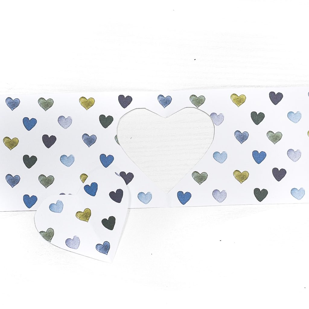 Heart Cut Out Mason Jar Votive - Easy Valentine Craft with Mason Jars, Scrapbook Paper. Scrapbook paper wrapped mason jar with hearts for Valentine's Day. Mason Jar Heart Votive for Valentine's.