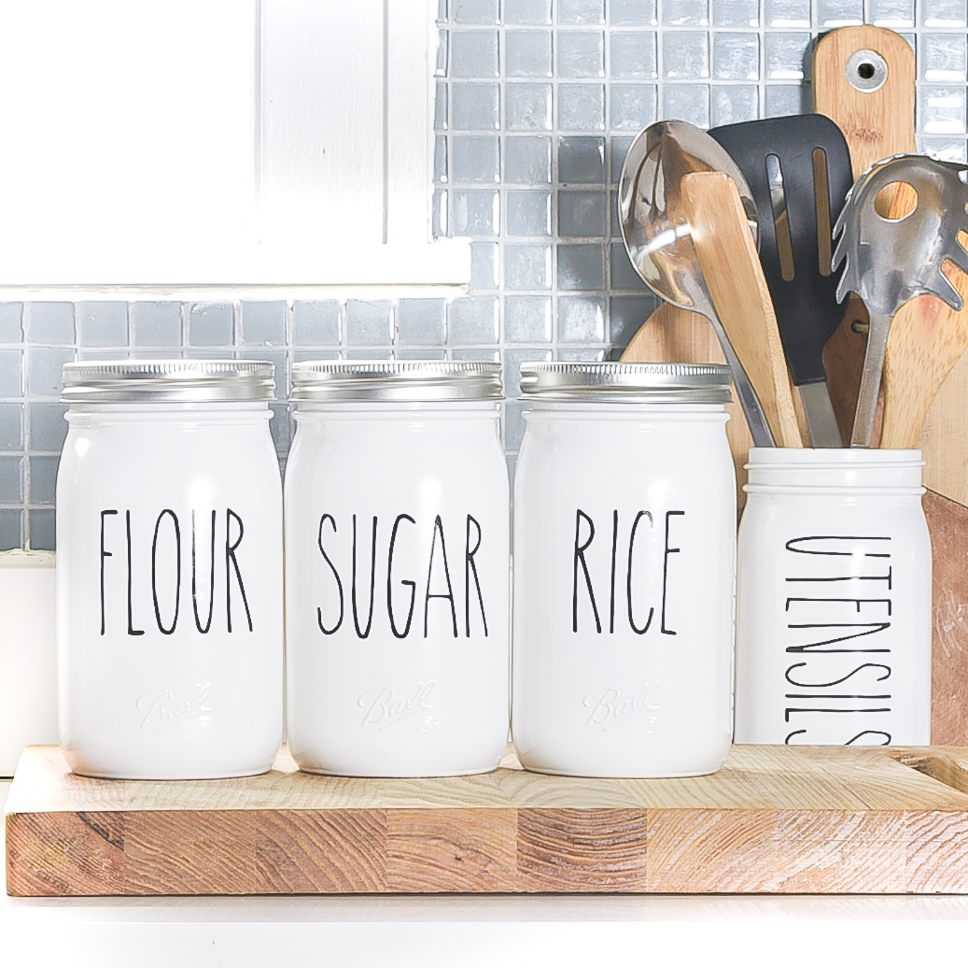 Rae Dunn-inspired mason jar kitchen canisters. Mason jar canister ideas. How to make Rae Dunn pottery, porcelain, canisters. DIY Rae Dunn masons jars.