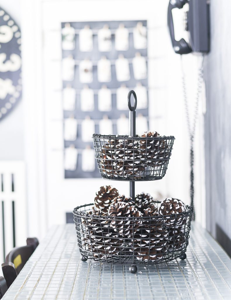 Painted Pine Cones Centerpiece. Christmas Kitchen with Mini Wreaths on Kitchen Cabinet Doors. How to Hange Mini Wreaths on Cabinet Doors. Mini Wreaths with Black and White Ribbon Decor Ideas. Black and White Christmas Decor Ideas.