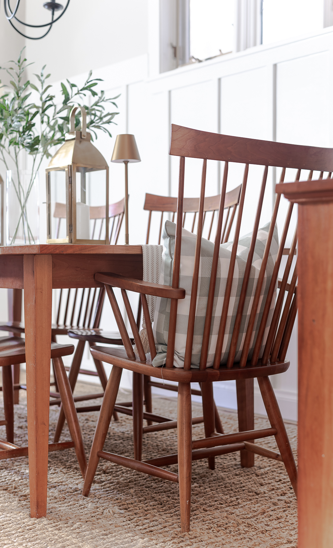 Board and batten dining room - shaker dining room in natural cherry - neutral dining room for spring - tan and white table runner - large gold lanterns - cordless lamps in gold