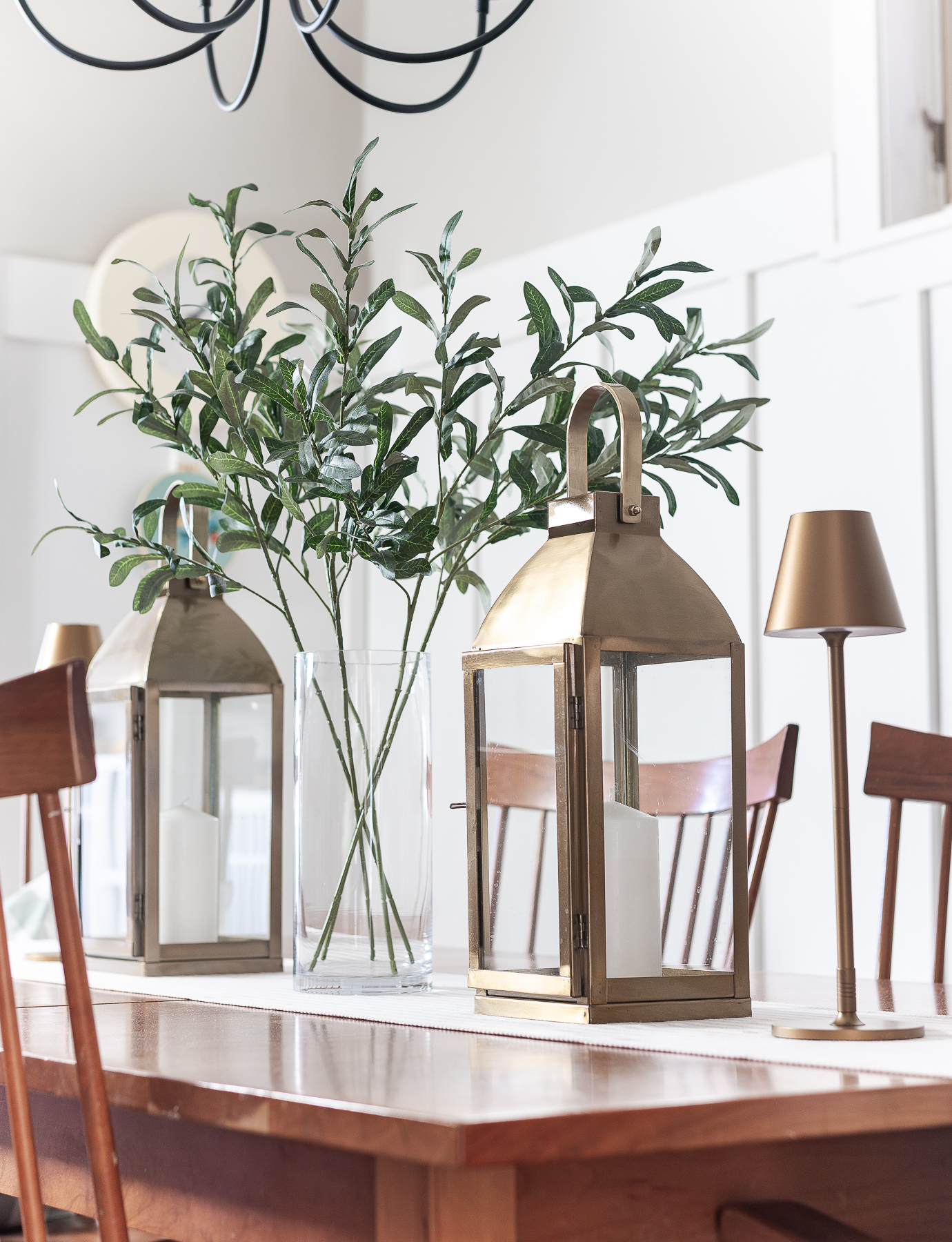 Board and batten dining room - shaker dining room in natural cherry - neutral dining room for spring - tan and white table runner - large gold lanterns - cordless lamps in gold