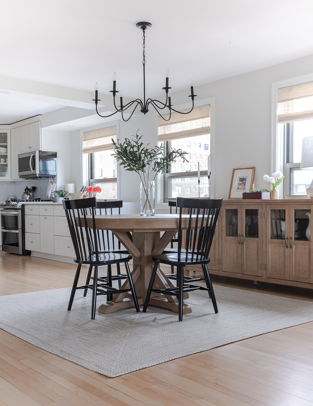 Neutral, White, Wood, Black Dining Room - Chicago Condo Dining Room Reveal - Black Iron Chandelier, Round Table, Black Windsor Chairs