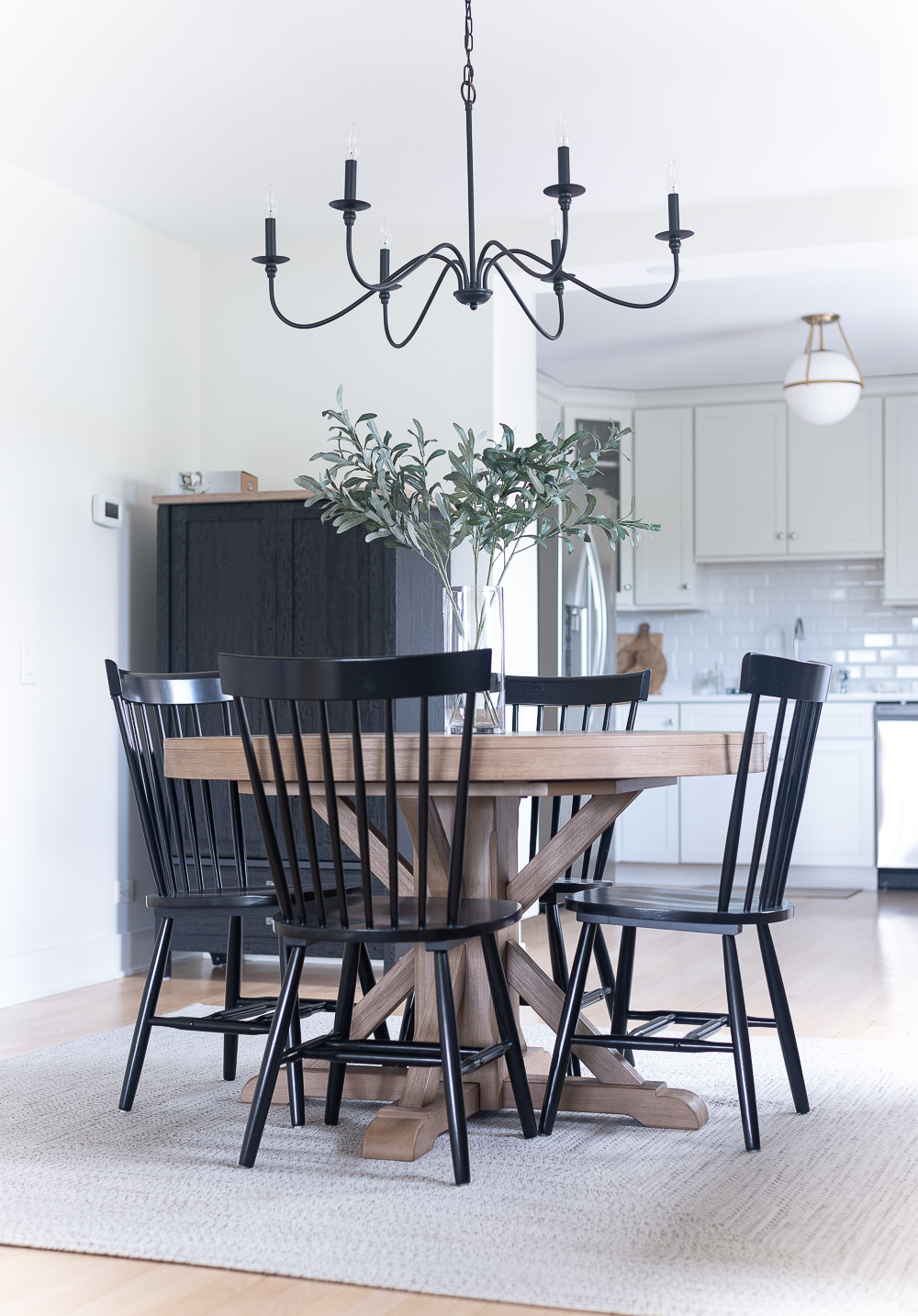 Neutral, White, Wood, Black Dining Room - Chicago Condo Dining Room Reveal - Black Iron Chandelier, Round Table, Black Windsor Chairs
