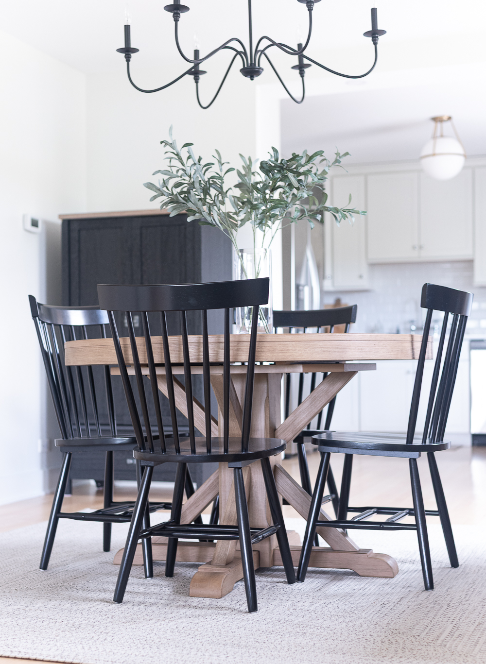 Neutral, White, Wood, Black Dining Room - Chicago Condo Dining Room Reveal - Black Iron Chandelier, Round Table, Black Windsor Chairs