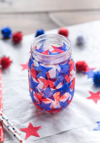 Tissue paper stained glass mason jar craft. Red white blue tissue paper craft. Mod Podge jar in red, white blue. Star shaped tissue paper decoupage mason.