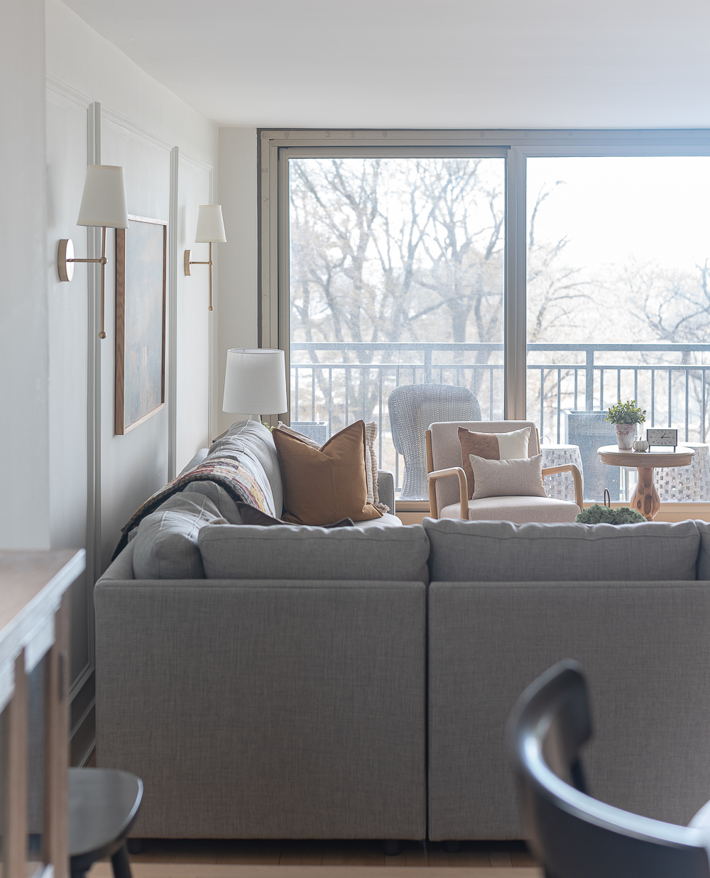 Fall Living Room in Rust, Brown, Mustard, Black, Gray, Neutral. Mustard PIllow. Faux Leather Ottomon from Amazon. Crate & Barrel Barrett Sectional Sofa. Pottery Barn TV Console. Wayfair Side Tables in Light Wood. Vintage Cow Print on Canvas.