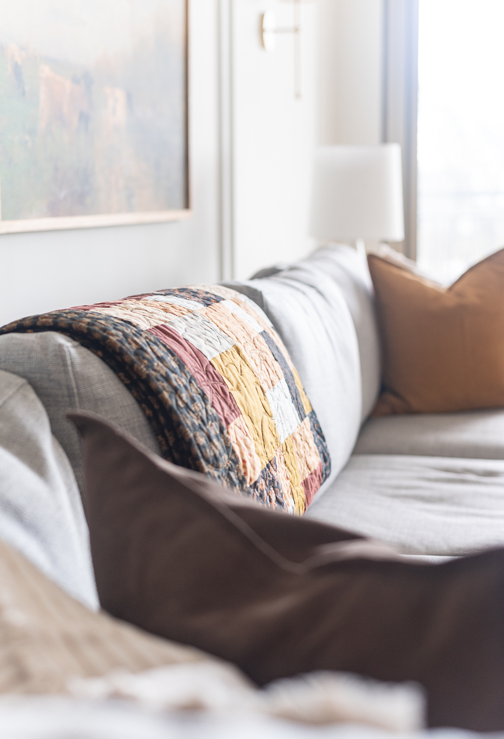 Fall Living Room in Rust, Brown, Mustard, Black, Gray, Neutral. Mustard PIllow. Faux Leather Ottomon from Amazon. Crate & Barrel Barrett Sectional Sofa. Pottery Barn TV Console. Wayfair Side Tables in Light Wood. Vintage Cow Print on Canvas.