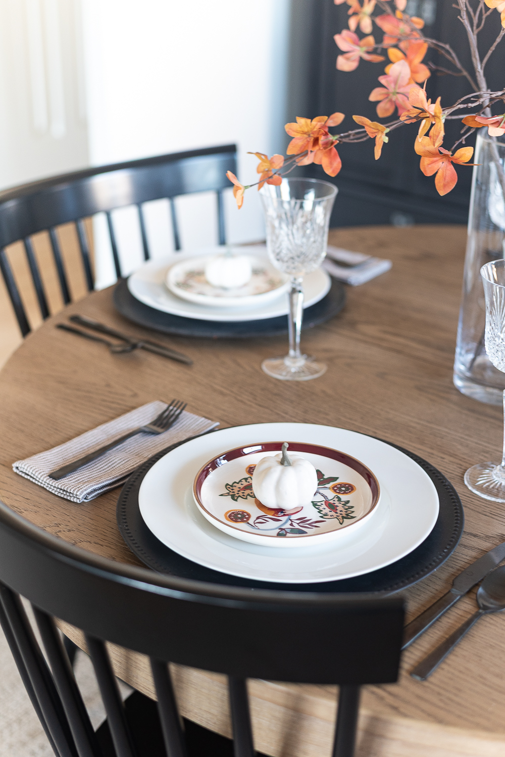 Thanksgiving Table Setting Ideas in Browns, Rusts, Oranges. White pumpkin table settings. Brown and cream ticking cloth napkins. Black flatware. Target decorative plates for fall. Fall Table Setting Ideas. Simple Fall Table.