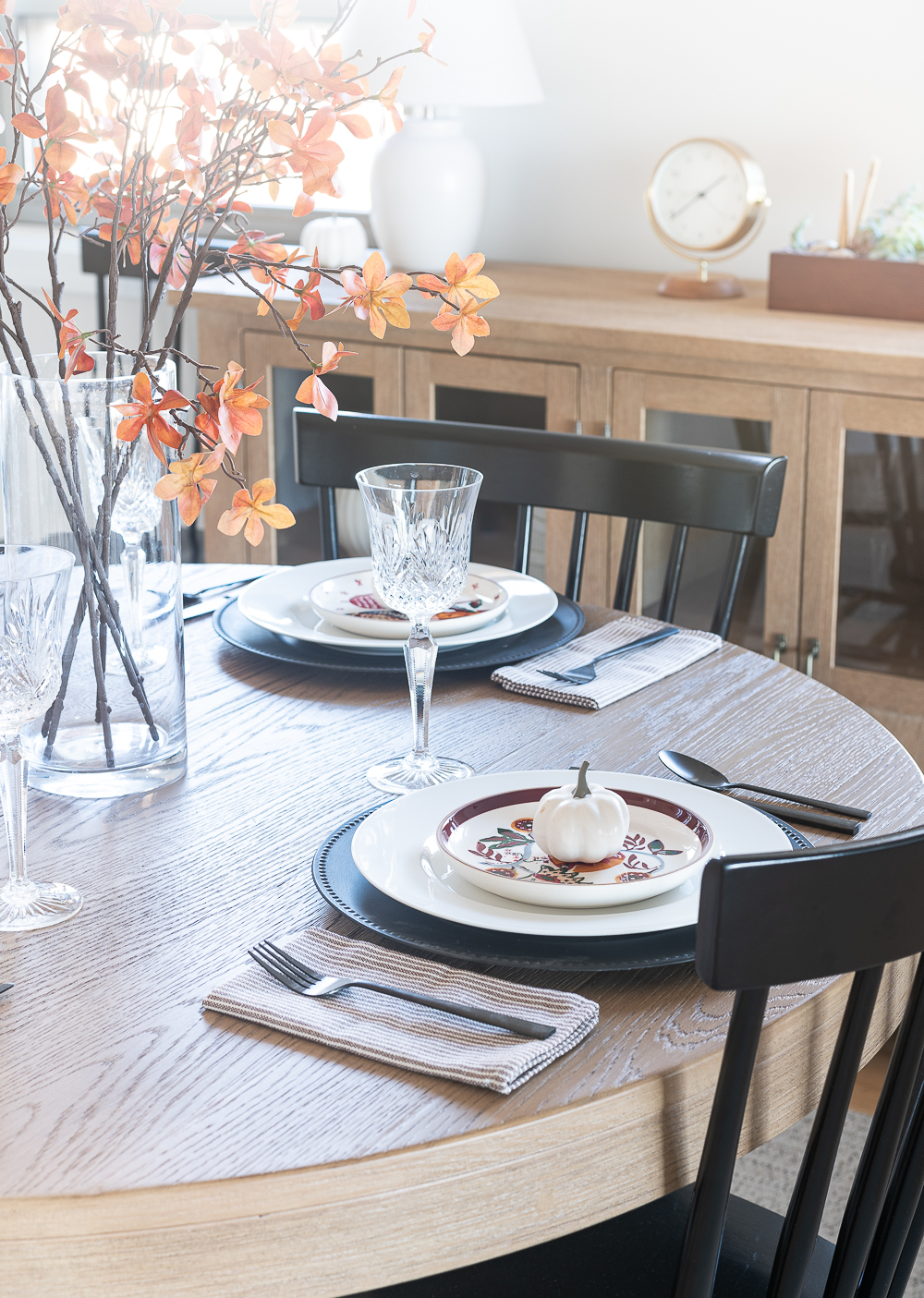 Thanksgiving Table Setting Ideas in Browns, Rusts, Oranges. White pumpkin table settings. Brown and cream ticking cloth napkins. Black flatware. Target decorative plates for fall. Fall Table Setting Ideas. Simple Fall Table.