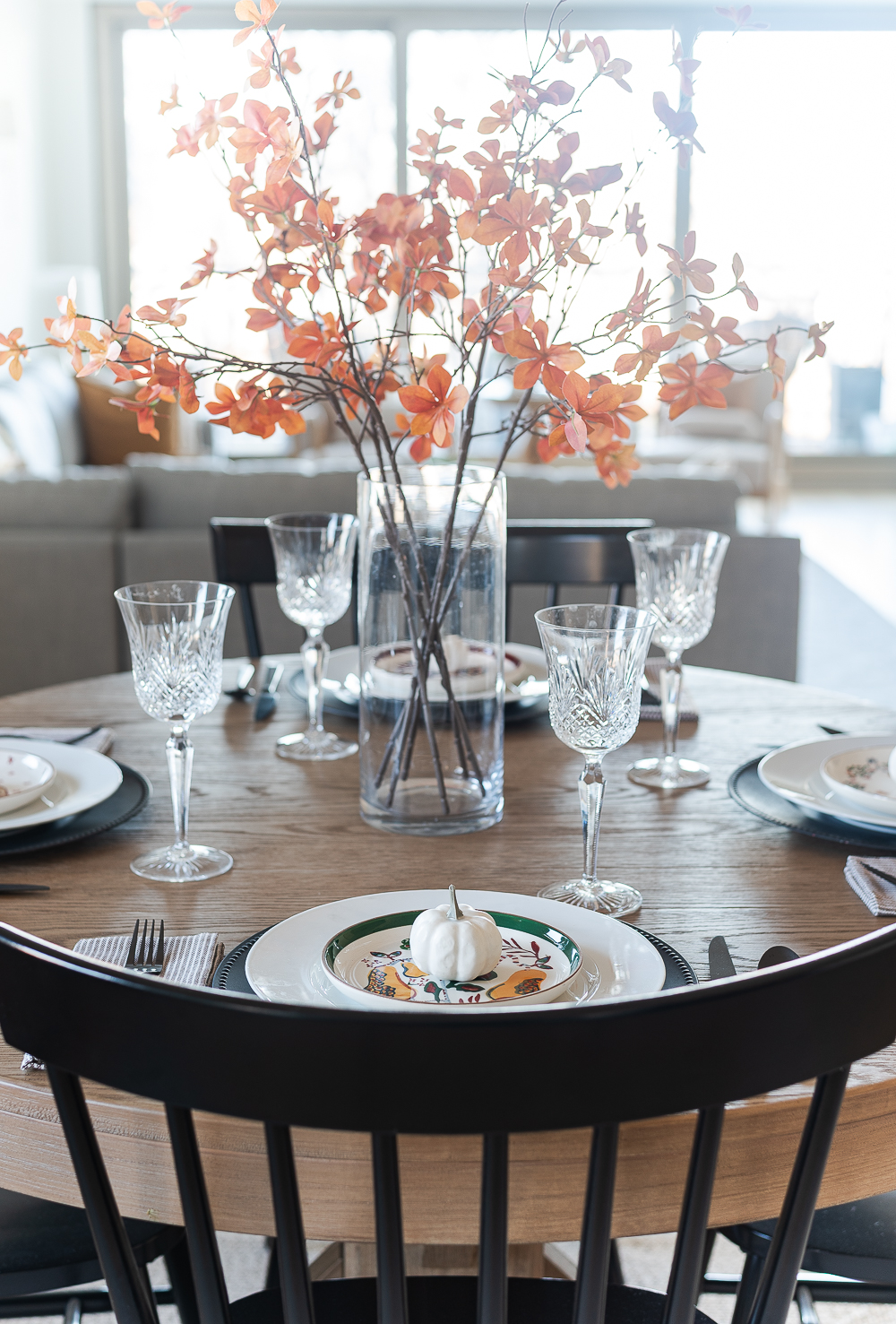 Thanksgiving Table Setting Ideas in Browns, Rusts, Oranges. White pumpkin table settings. Brown and cream ticking cloth napkins. Black flatware. Target decorative plates for fall. Fall Table Setting Ideas. Simple Fall Table.