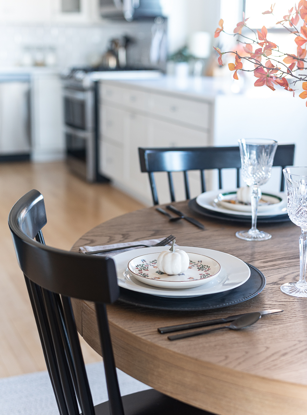 Thanksgiving Table Setting Ideas in Browns, Rusts, Oranges. White pumpkin table settings. Brown and cream ticking cloth napkins. Black flatware. Target decorative plates for fall. Fall Table Setting Ideas. Simple Fall Table.