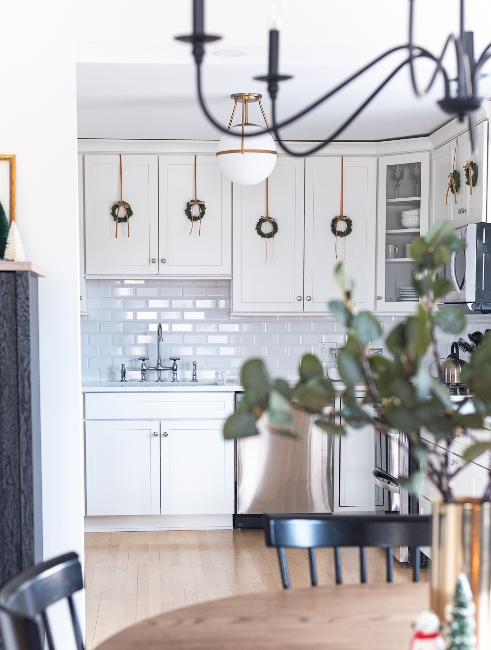 Wreaths on Kitchen Cabinets for Christmas. Decorating the Kitchen for Christmas. Decorating the Kitchen with Mini Wreaths and Velvet Ribbons and Bows.