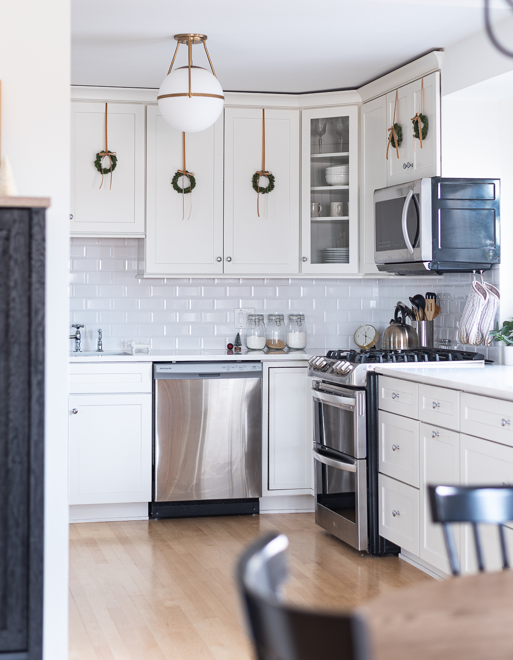 Wreaths on Kitchen Cabinets for Christmas. Decorating the Kitchen for Christmas. Decorating the Kitchen with Mini Wreaths and Velvet Ribbons and Bows.