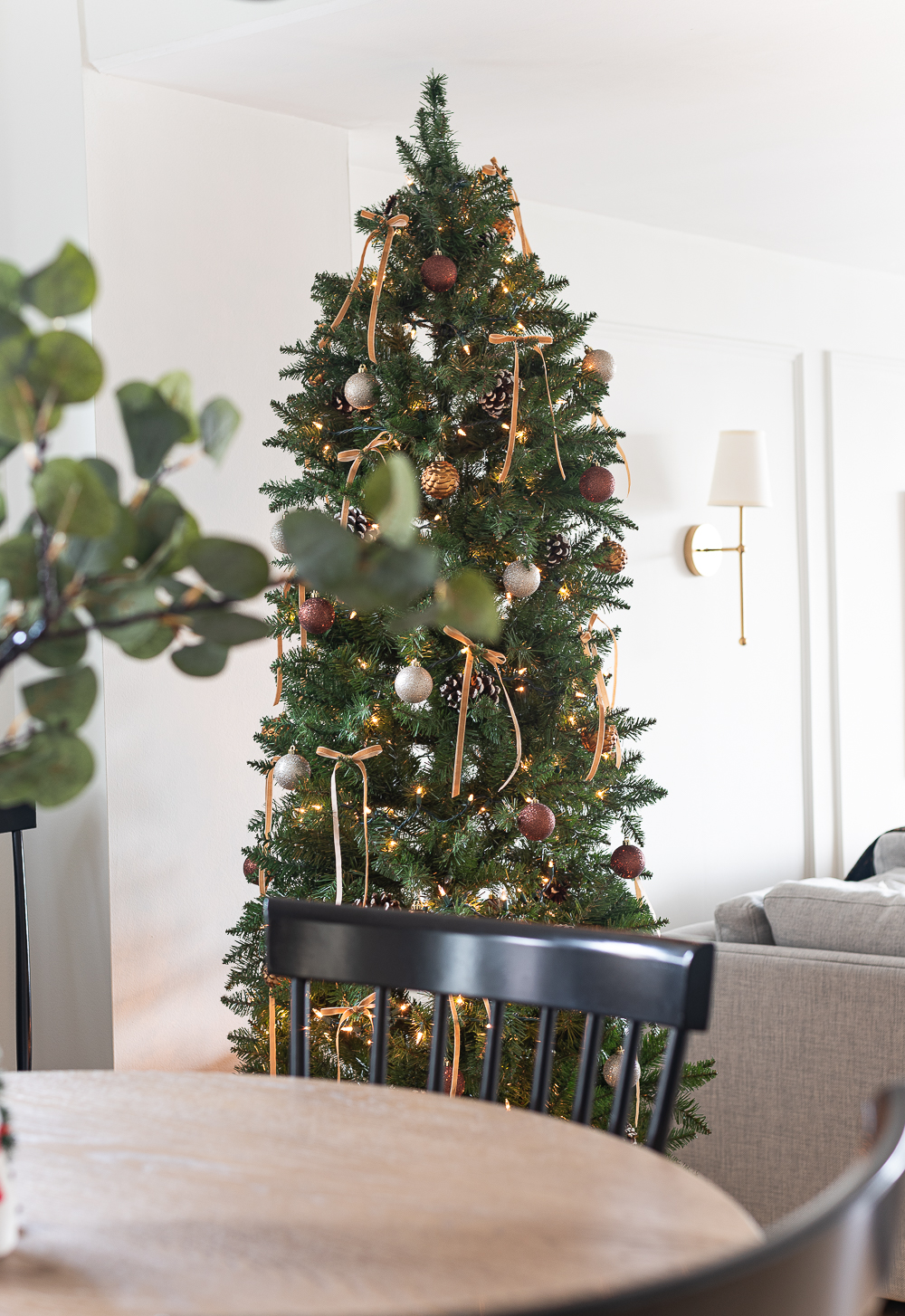 Christmas in the Dining Room. Neutral Christmas with Khaki Velvet Bows, Browns, Burgundies, Gold. Rustic Christmas Tree with Painted Pine Cones, Neutral Light Brown Velvet Ribbons, Gold, Burgundy, Brown Balls.